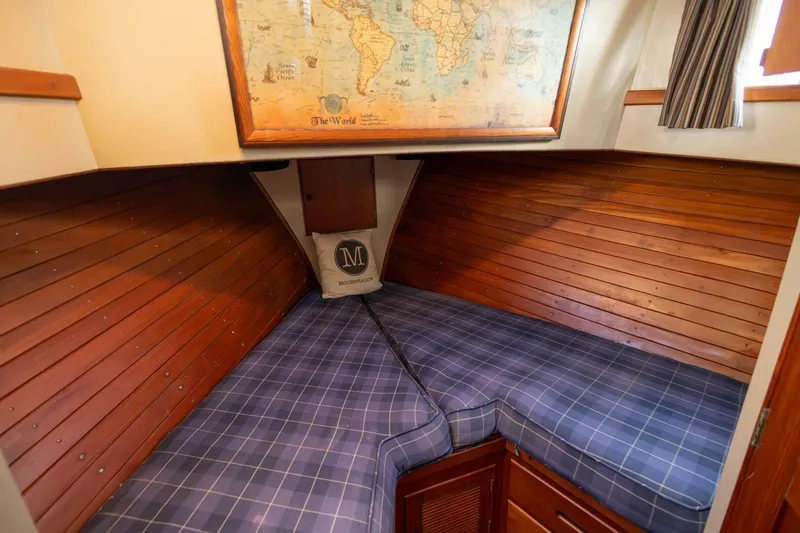 Slide: The Image of Cozy cabin interior of 1985 Grand Banks 42 Classic with plaid bedding and world map decor. - 17