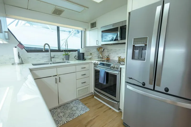 Slide: The Image of Modern kitchen in 1989 Hatteras Custom Cockpit yacht with stainless steel appliances. - 18