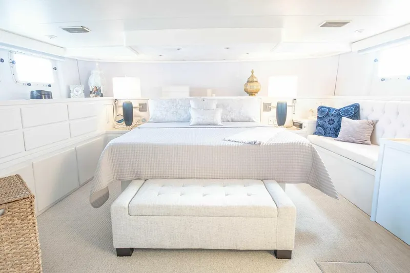 Slide: The Image of Luxurious 1989 Hatteras Custom Cockpit yacht bedroom with elegant decor and ample natural light. - 28