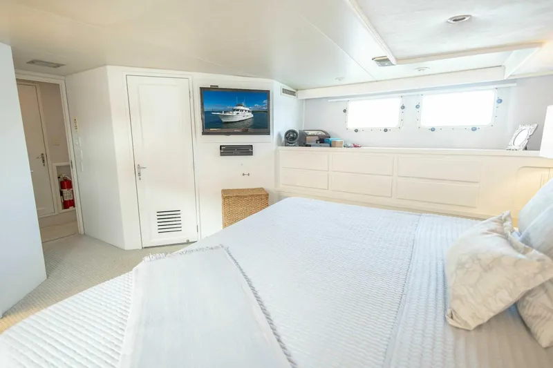 Slide: The Image of Luxurious 1989 Hatteras Custom Cockpit yacht bedroom with TV and modern decor. - 32