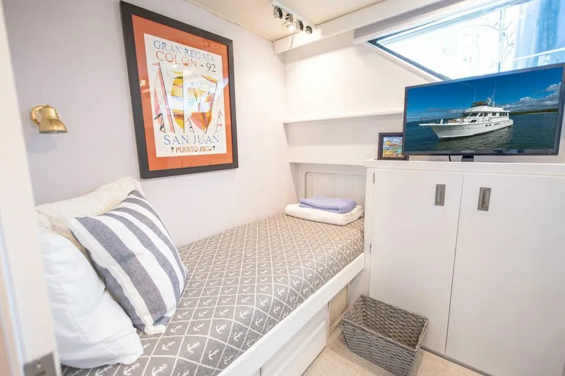 Slide: The Image of Cozy cabin interior of 1989 Hatteras Custom Cockpit yacht with bed, TV, and nautical decor. - 39