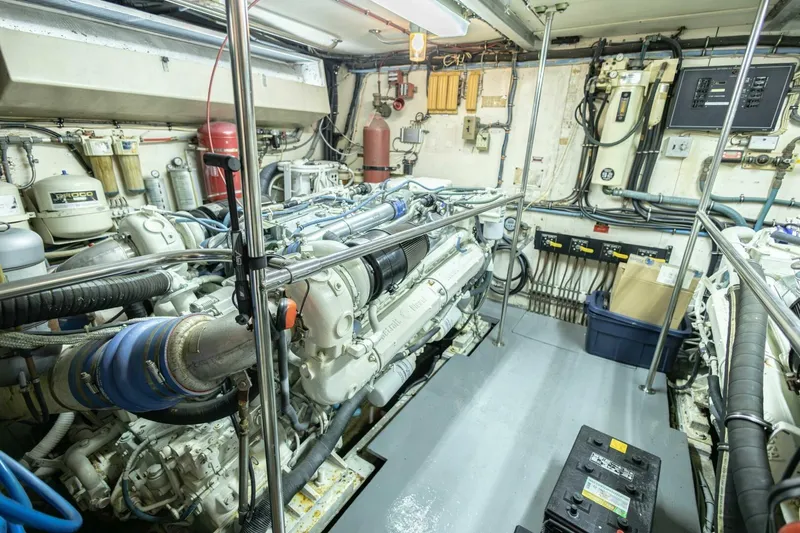 Slide: The Image of Engine room of 1989 Hatteras Custom Cockpit yacht, showcasing machinery and equipment. - 63