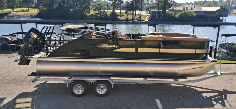 The Image of 2026 Bentley Pontoons Legacy 223 Swingback on trailer by the water. - 0