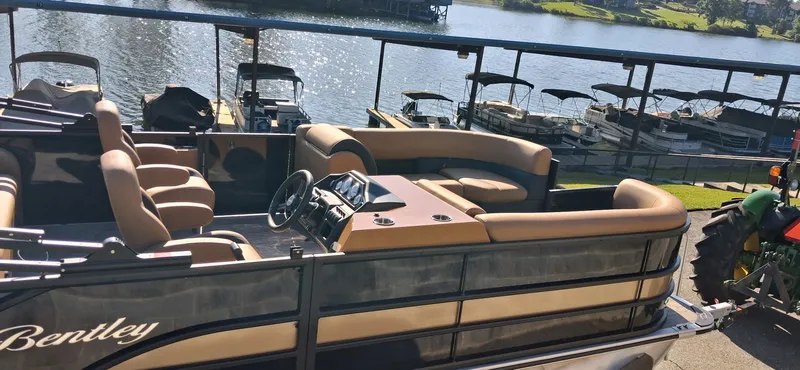 Slide: The Image of 2026 Bentley Pontoons Legacy 223 Swingback by the lakeside. - 11
