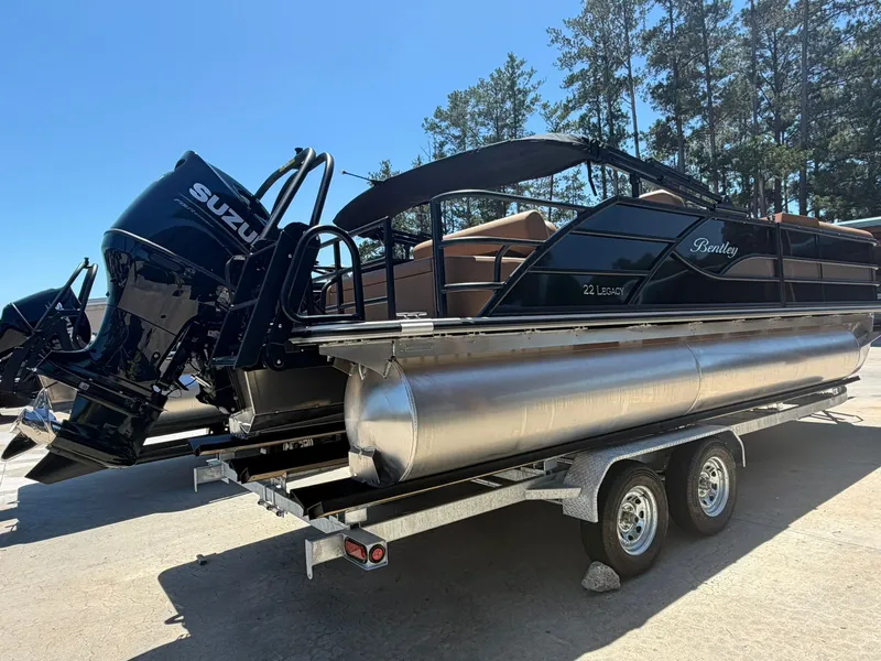 Slide: The Image of 2026 Bentley Pontoons Legacy 223 on trailer, Suzuki engine, sunny day. - 2