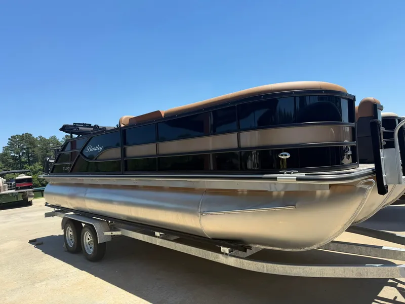 Slide: The Image of 2026 Bentley Pontoons Legacy 223 Swingback on trailer, sunny day. - 7