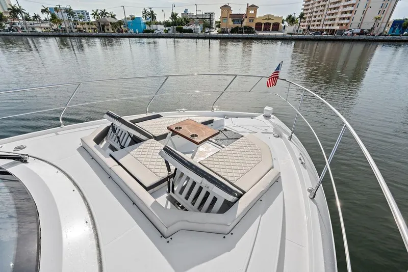 Slide: The Image of Luxurious 2022 Cruisers Yachts 46 Cantius with elegant deck seating and waterfront view. - 10