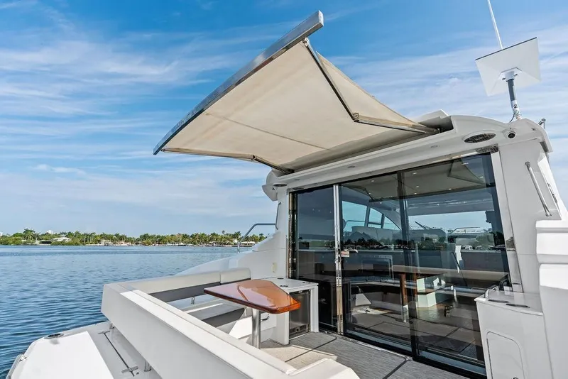 Slide: The Image of Luxury 2022 Cruisers Yachts 46 Cantius with open deck and scenic water view. - 19