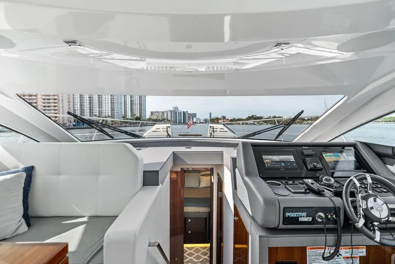 Slide: The Image of 2022 Cruisers Yachts 46 Cantius helm with modern controls and waterfront view. - 27