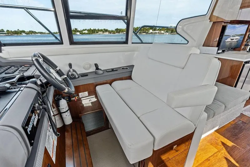 Slide: The Image of Interior of 2022 Cruisers Yachts 46 Cantius with helm and seating area. - 30