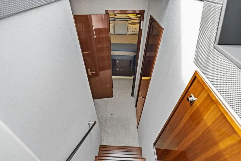 Slide: The Image of Interior view of 2022 Cruisers Yachts 46 Cantius, featuring a hallway and cabin entrance. - 35