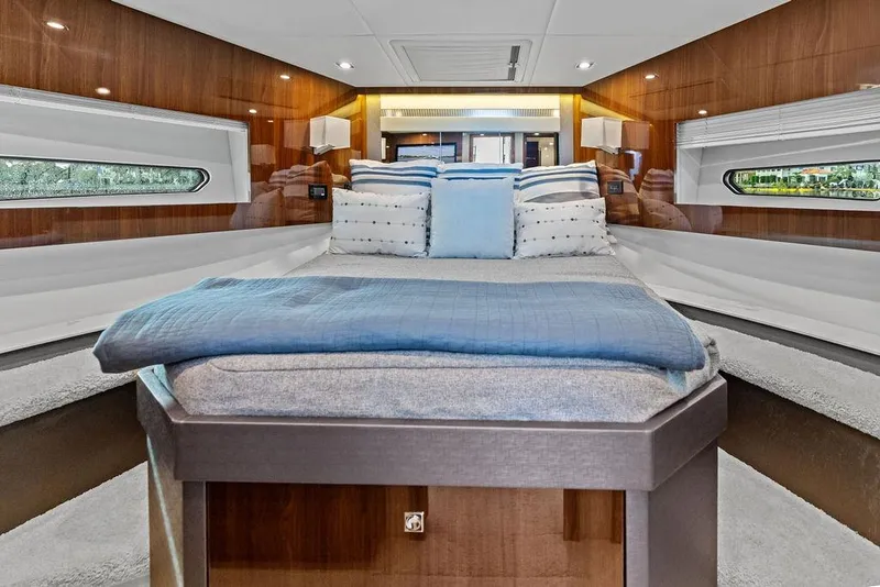 Slide: The Image of Luxurious interior of 2022 Cruisers Yachts 46 Cantius with elegant bedding and wood paneling. - 38