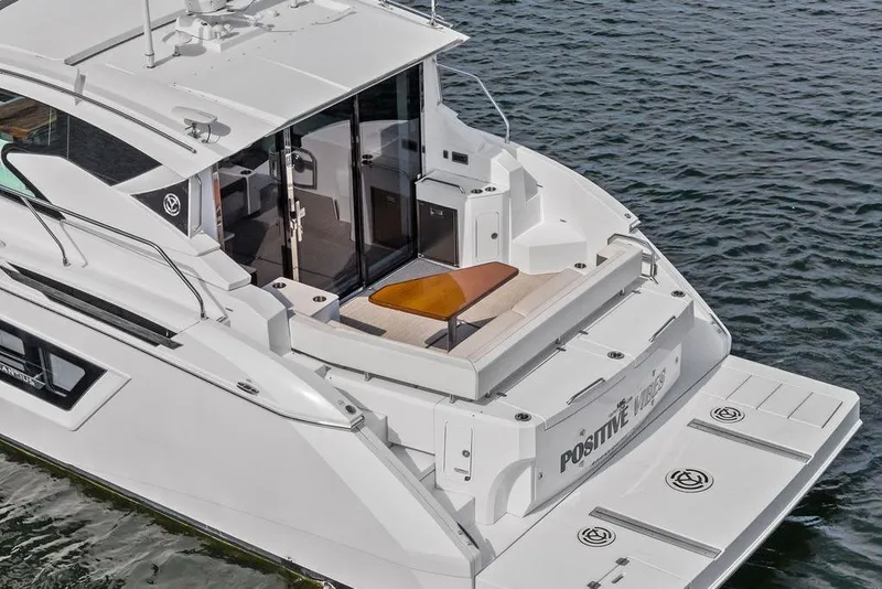 Slide: The Image of 2022 Cruisers Yachts 46 Cantius on water, featuring spacious deck and modern design. - 4