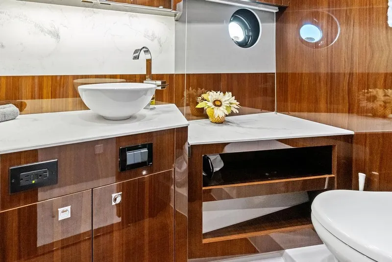 Slide: The Image of Luxurious bathroom in 2022 Cruisers Yachts 46 Cantius with modern fixtures and elegant wood finish. - 47