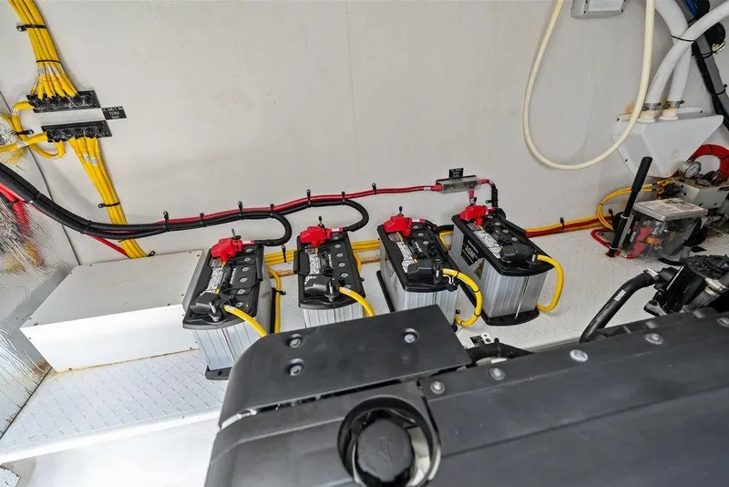 Slide: The Image of Engine room of 2022 Cruisers Yachts 46 Cantius with batteries and wiring. - 53