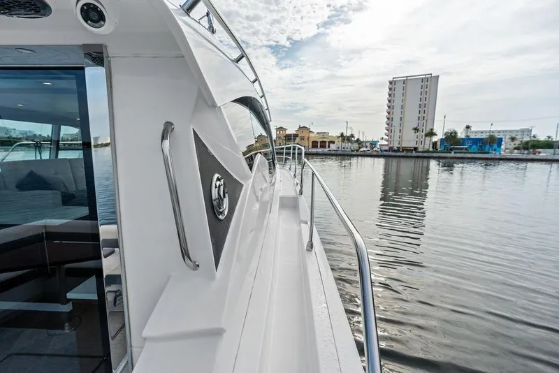 Slide: The Image of 2022 Cruisers Yachts 46 Cantius on calm water near urban skyline. - 6