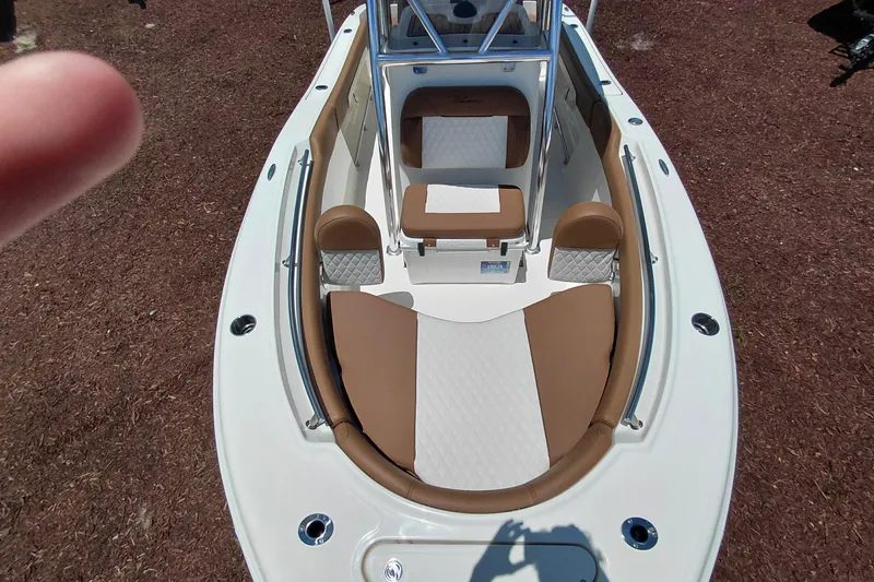 Slide: The Image of 2026 Pioneer 202 Sportfish boat interior with brown and white cushioned seating. - 10