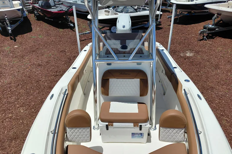 Slide: The Image of 2026 Pioneer 202 Sportfish boat interior with tan seating and stainless steel fixtures. - 12
