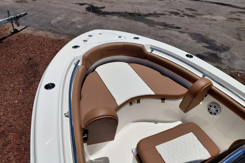 Slide: The Image of 2026 Pioneer 202 Sportfish boat with brown and white cushioned seating. - 13