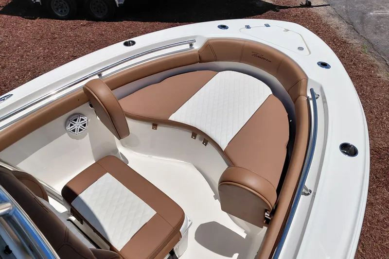 Slide: The Image of 2026 Pioneer 202 Sportfish boat interior with tan and white cushioned seating. - 14