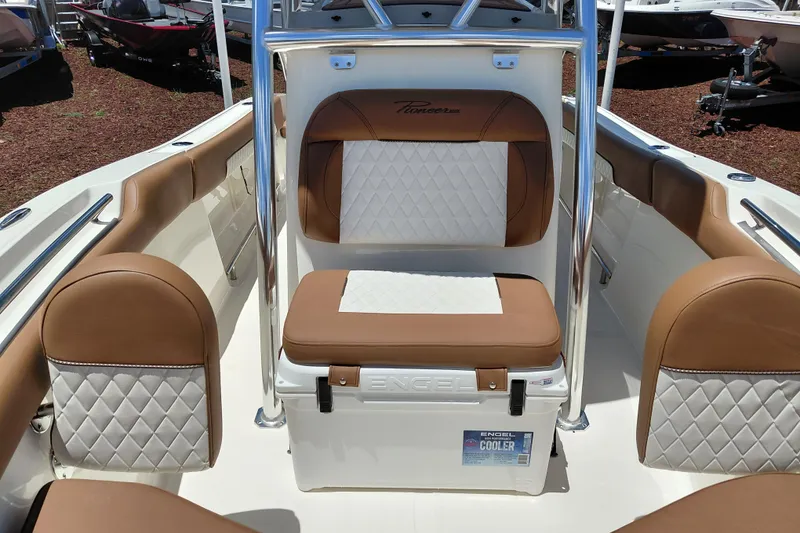 Slide: The Image of 2026 Pioneer 202 Sportfish boat interior with brown and white cushioned seating. - 15