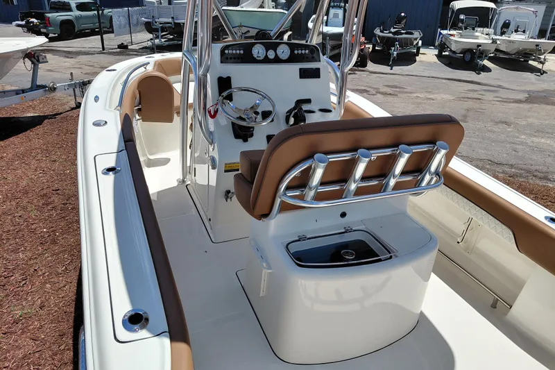 Slide: The Image of 2026 Pioneer 202 Sportfish boat interior with helm, seating, and rod holders. - 18