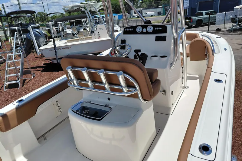 Slide: The Image of 2026 Pioneer 202 Sportfish boat interior with helm, seating, and fishing rod holders. - 19