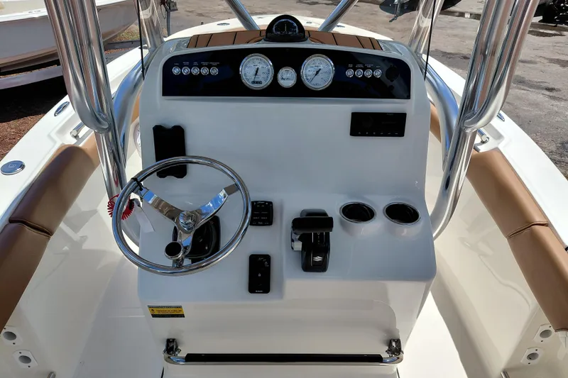 Slide: The Image of 2026 Pioneer 202 Sportfish boat console with steering wheel and gauges. - 21