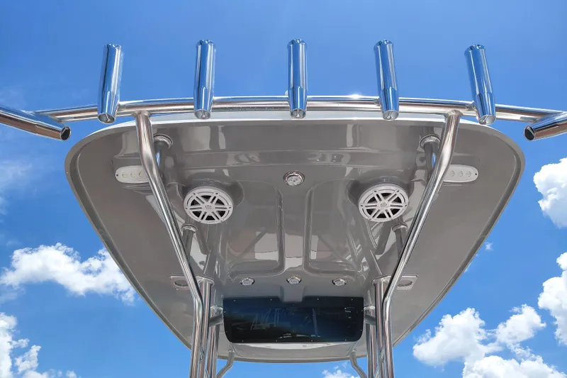 Slide: The Image of 2026 Pioneer 202 Sportfish boat's T-top with rod holders against blue sky. - 22