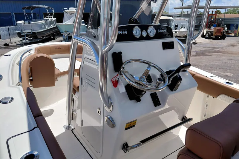 Slide: The Image of 2026 Pioneer 202 Sportfish boat interior with steering console and seating. - 23