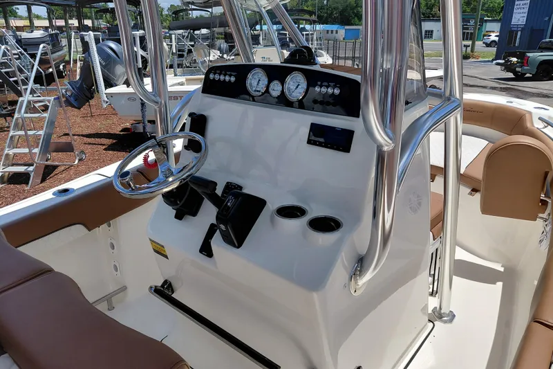 Slide: The Image of 2026 Pioneer 202 Sportfish boat dashboard with steering wheel and gauges. - 24