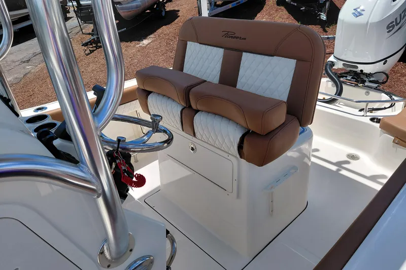 Slide: The Image of 2026 Pioneer 202 Sportfish boat interior with cushioned seating and stainless steel railings. - 26