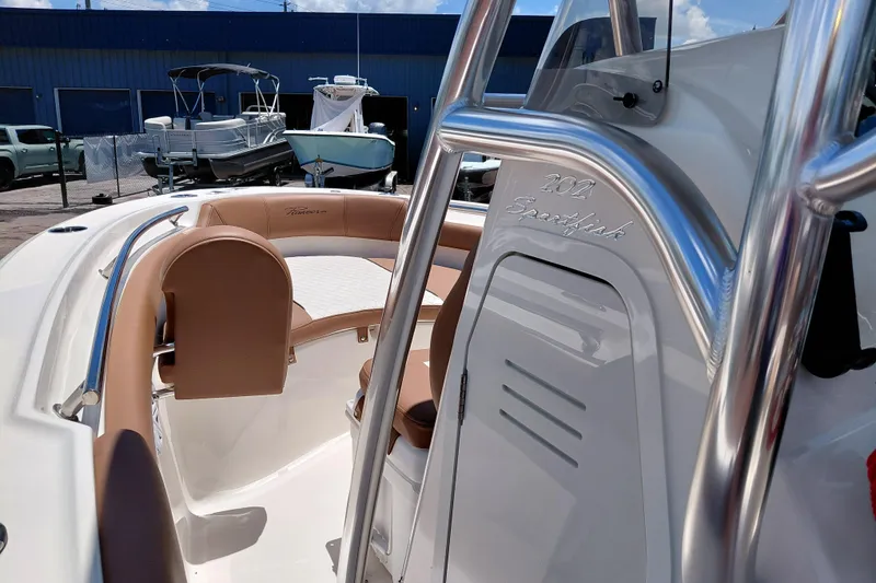 Slide: The Image of 2026 Pioneer 202 Sportfish boat interior with tan seating and stainless steel details. - 28