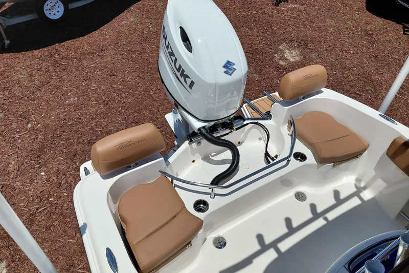 Slide: The Image of 2026 Pioneer 202 Sportfish boat with Suzuki outboard motor and tan seating. - 31