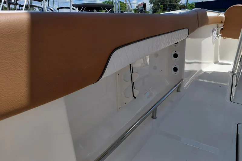 Slide: The Image of 2026 Pioneer 202 Sportfish boat interior with tan and white seating detail. - 34