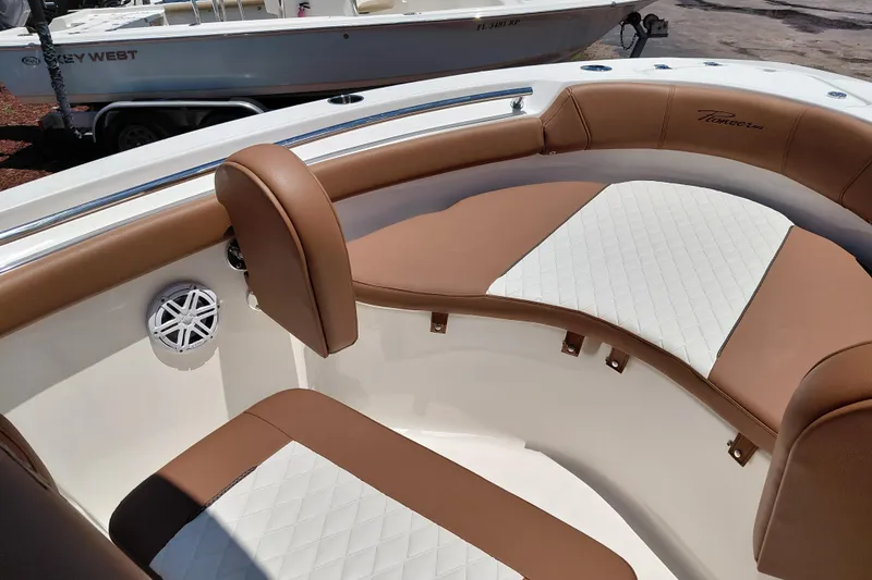 Slide: The Image of 2026 Pioneer 202 Sportfish boat interior with brown and white cushioned seating. - 39