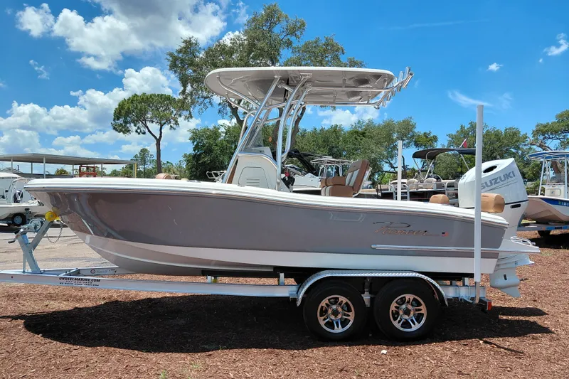 Slide: The Image of 2026 Pioneer 202 Sportfish boat on trailer under clear blue sky. - 4