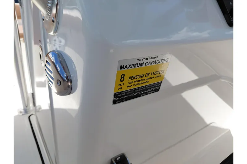 Slide: The Image of 2026 Pioneer 202 Sportfish boat capacity label, indicating maximum of 8 persons or 1160 lbs. - 40