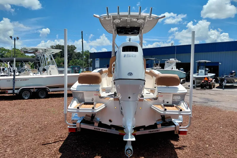 Slide: The Image of 2026 Pioneer 202 Sportfish boat with powerful outboard motor, displayed outdoors under blue sky. - 6