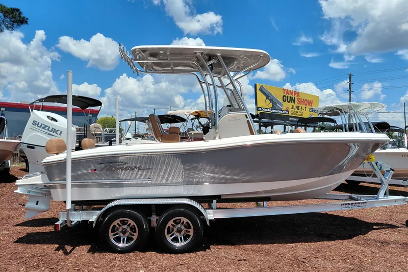 Slide: The Image of 2026 Pioneer 202 Sportfish boat on trailer, displayed outdoors under a blue sky. - 8