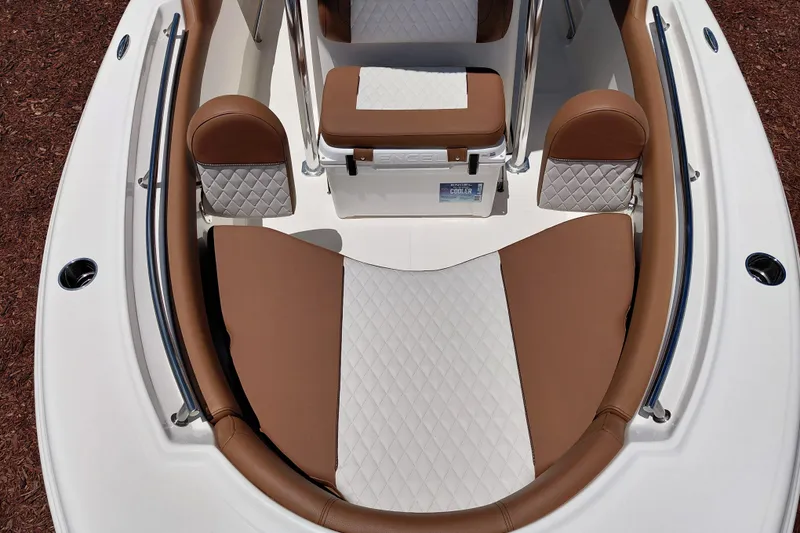 Slide: The Image of 2026 Pioneer 202 Sportfish boat interior with brown and white cushioned seating. - 9