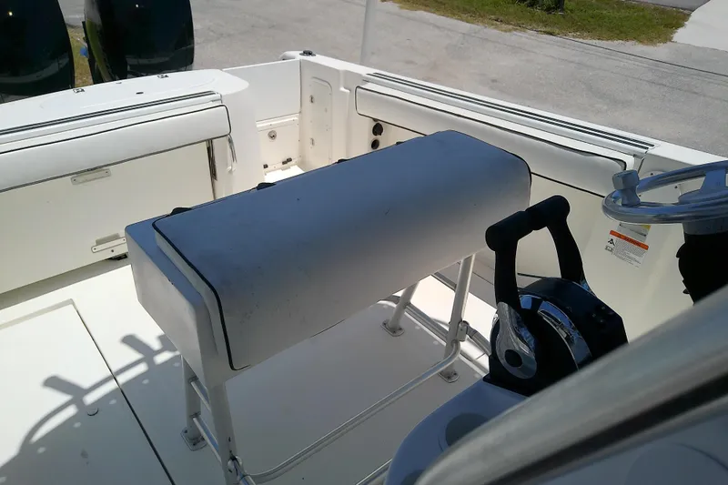 Slide: The Image of Interior view of a 2003 Wellcraft 250 Fisherman boat, featuring helm and seating area. - 12