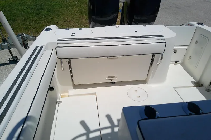 Slide: The Image of 2003 Wellcraft 250 Fisherman boat interior with seating and storage compartments. - 13