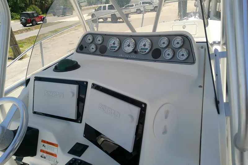 Slide: The Image of Dashboard of a 2003 Wellcraft 250 Fisherman boat with Simrad equipment and gauges. - 16