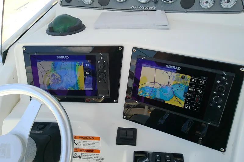 Slide: The Image of Dashboard of a 2003 Wellcraft 250 Fisherman with Simrad navigation displays. - 19