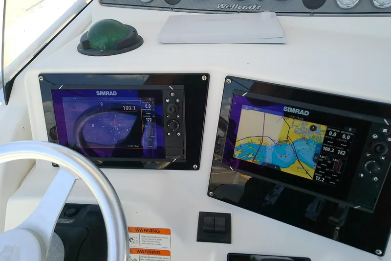 Slide: The Image of Dashboard of a 2003 Wellcraft 250 Fisherman with dual Simrad navigation displays. - 20