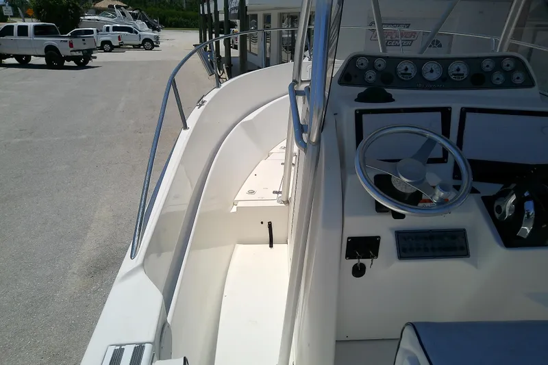 Slide: The Image of 2003 Wellcraft 250 Fisherman boat interior with steering wheel and dashboard controls. - 23