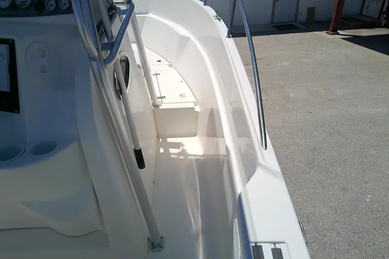 Slide: The Image of 2003 Wellcraft 250 Fisherman boat interior with steering console and railings. - 24
