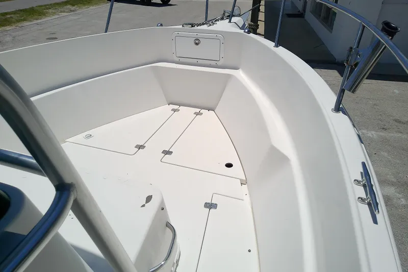 Slide: The Image of 2003 Wellcraft 250 Fisherman boat deck, featuring spacious storage compartments and sleek design. - 25