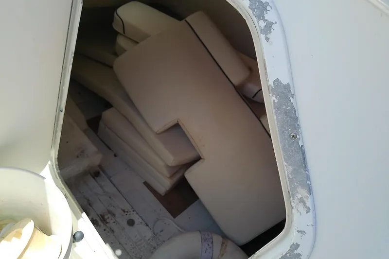 Slide: The Image of Cushions stored inside a 2003 Wellcraft 250 Fisherman boat compartment. - 29